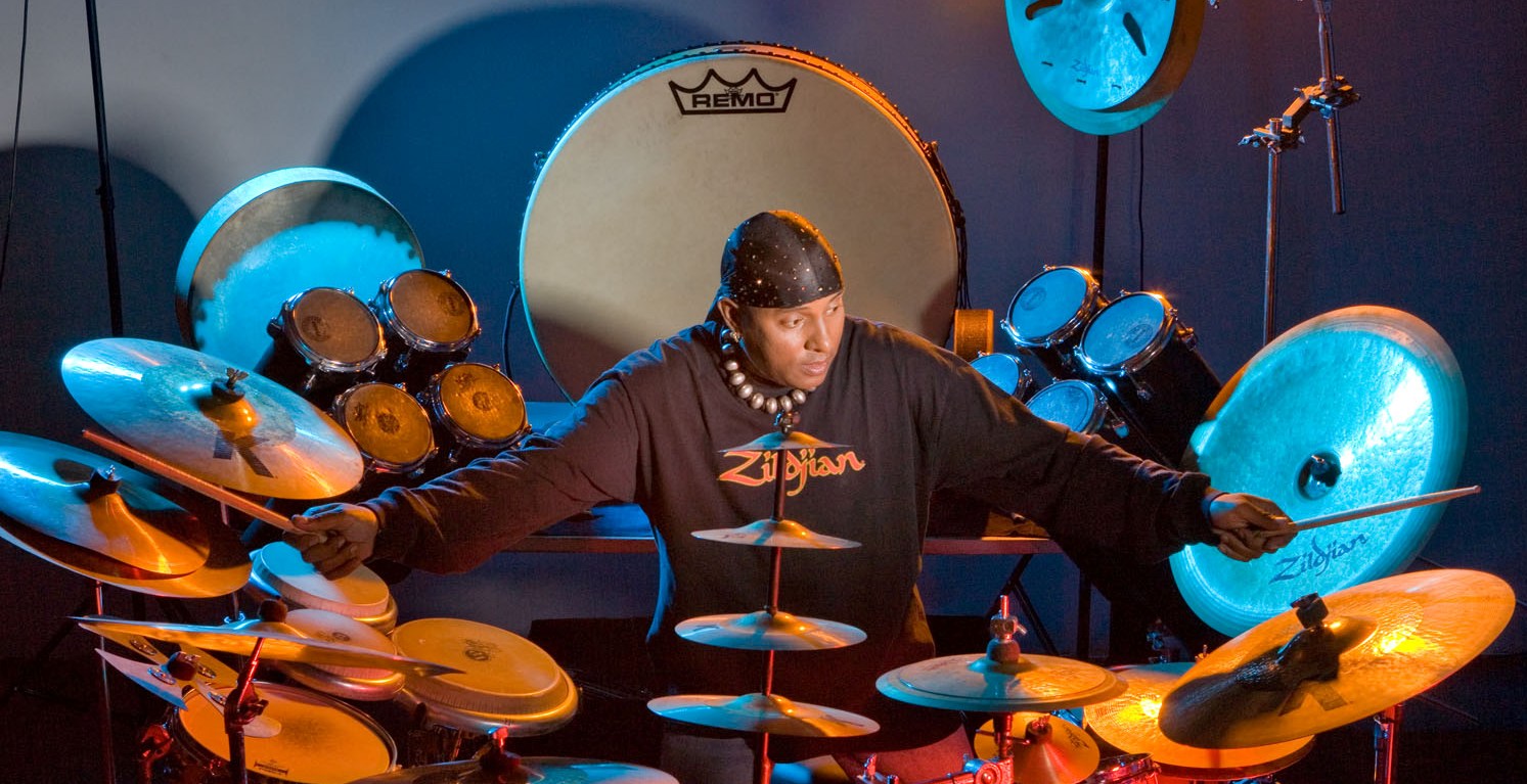 why does drums sivamani covers his head