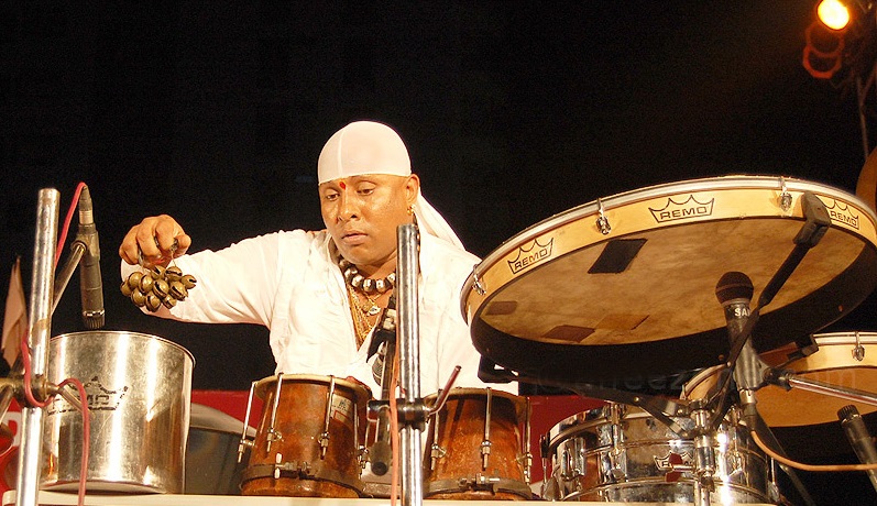 why does drums sivamani covers his head